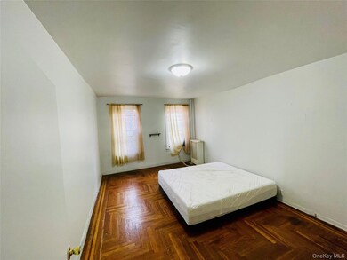 Bedroom with baseboards and radiator heating unit
