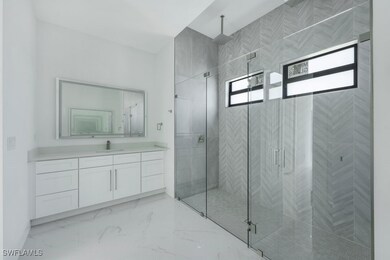 Bathroom featuring walk in shower and vanity