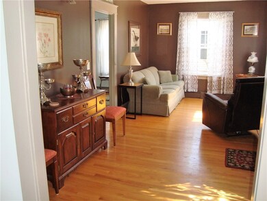 Sunny living room with period details and hardwood