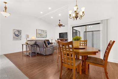 Dining space featuring a ceiling fan, wood finished floors, a chandelier, and recessed lighting