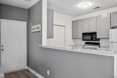 Foyer/entry view to front door, kitchen and laundr