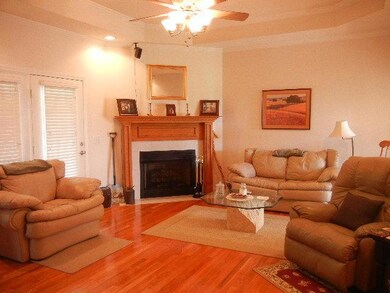 This spacious living room provides enough seating for the family to get cozy around the fireplace.