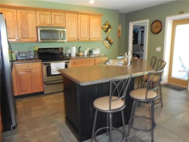 Kitchen has eat-on counter, stainless steel applia