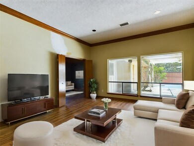 Living room featuring a textured ceiling, dark har