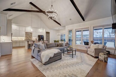 Living room featuring a chandelier, high vaulted c