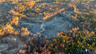 Aerial view of property and surrounding area with a heavily wooded area