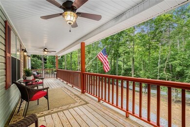 Wooden deck featuring ceiling fan and covered porc