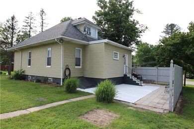 Rear View Of Home With Patio and New Railing On Ba