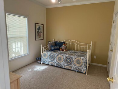 Bedroom featuring carpet and crown molding
