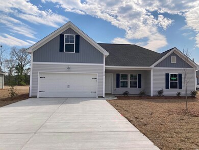 View of front of property featuring a garage, driv