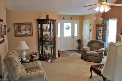 Living room with parquet entry, gas log fireplace and vaulted ceiling