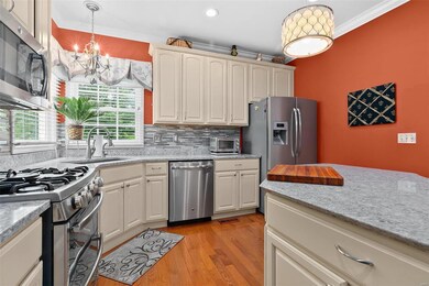 Quartz counter tops, tiled backsplash, gas range, 