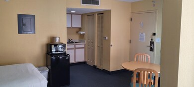 Kitchen featuring dark colored carpet, electric pa