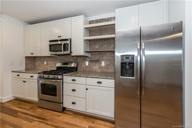 Stainless steel appliances and open shelving