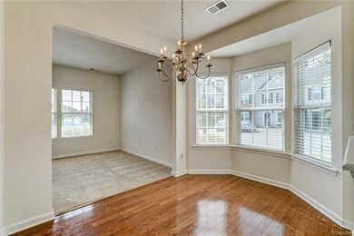 Dining room with hardwood floors and bay window