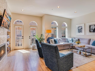 Living room with wood finished floors, recessed l
