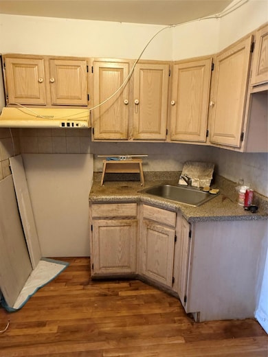 Kitchen with wood finished floors and a sink