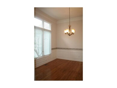 Formal dining with pristine wood floor, updated fi