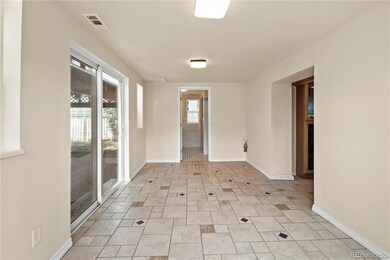Sunroom with slider door to backyard & pergola