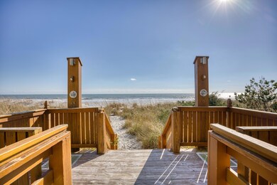 Deck with a water view and a beach view