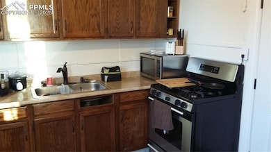 Kitchen featuring brown cabinets, open shelves, a 