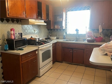 Kitchen with white electric range oven, stainless