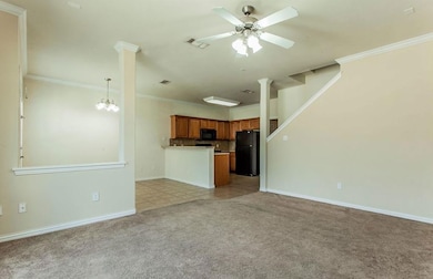 Unfurnished living room with crown molding, light