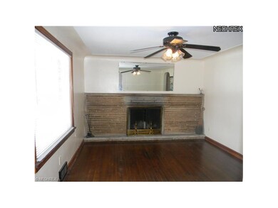 Living room with fireplace and harwood floor.