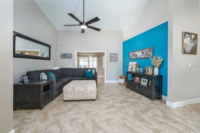 As you enter the front door you see a large tiled living room.