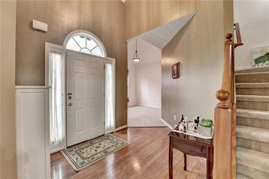 Entryway with wood finished floors, stairs, and a 