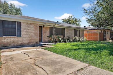 View of front of house with brick siding and roof with shingles