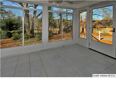 Beautiful and inviting glassed-in front porch.