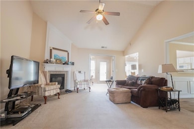 Living area featuring a fireplace, carpet floors, 