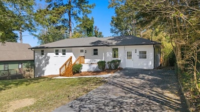 Single story home with a front yard, brick siding, and driveway