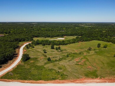 Aerial view of property and surrounding area with a forest