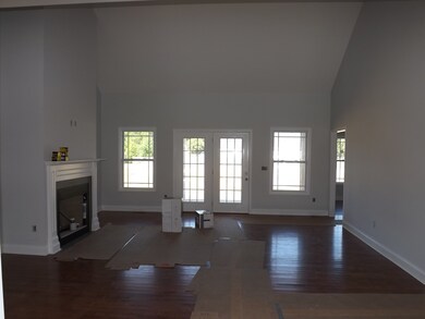 Features of the Great Room are fireplace, cathedral ceiling, hardwood floors and bright windows overlooking the covered back porch.