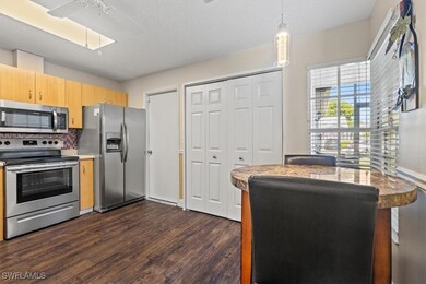 Kitchen featuring decorative backsplash, dark hard