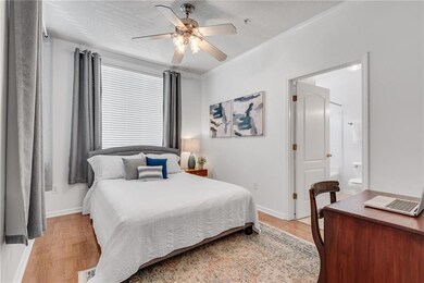 A private, separate bedroom features a large ensuite bathroom and a generously-sized custom walk-in closet.