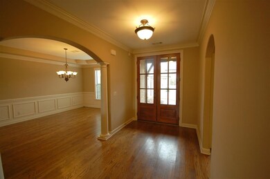 Stunning entry with gleaming hardwood floors and  