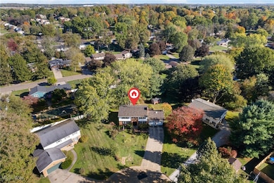 Aerial view of property's location featuring nearby suburban area