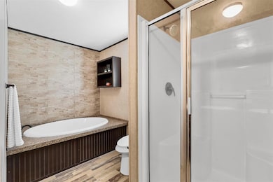 Bathroom featuring toilet, hardwood / wood-style f