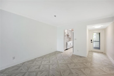 Spare room with a sink, baseboards, and crown molding