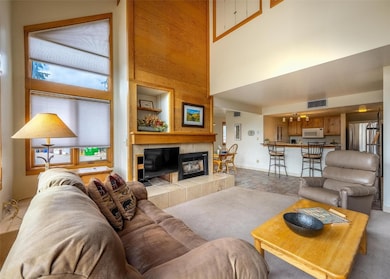 Living room featuring baseboards, visible vents, a