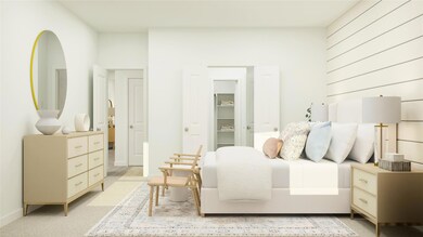 Bedroom featuring light carpet, a spacious closet,