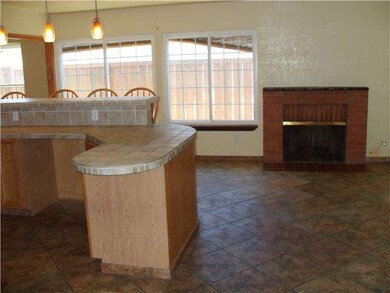 The family room with fireplace by the kitchen.