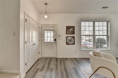 Entryway featuring light wood finished floors, bas