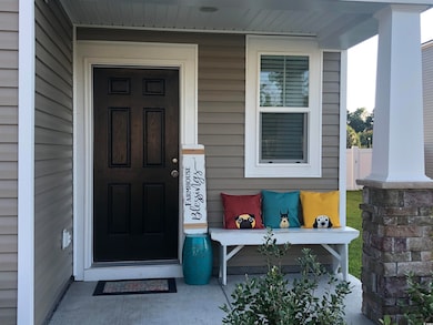 View of exterior entry featuring covered porch