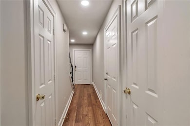 Hall featuring recessed lighting and dark wood-style floors