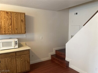 Stairs featuring wood finished floors and baseboar