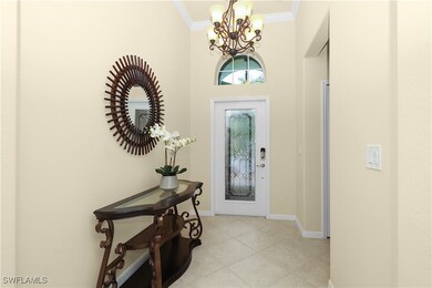 Entryway with light tile patterned floors, baseboa